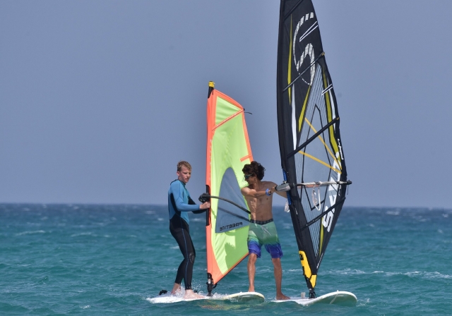  Friends practicing paddle surfing